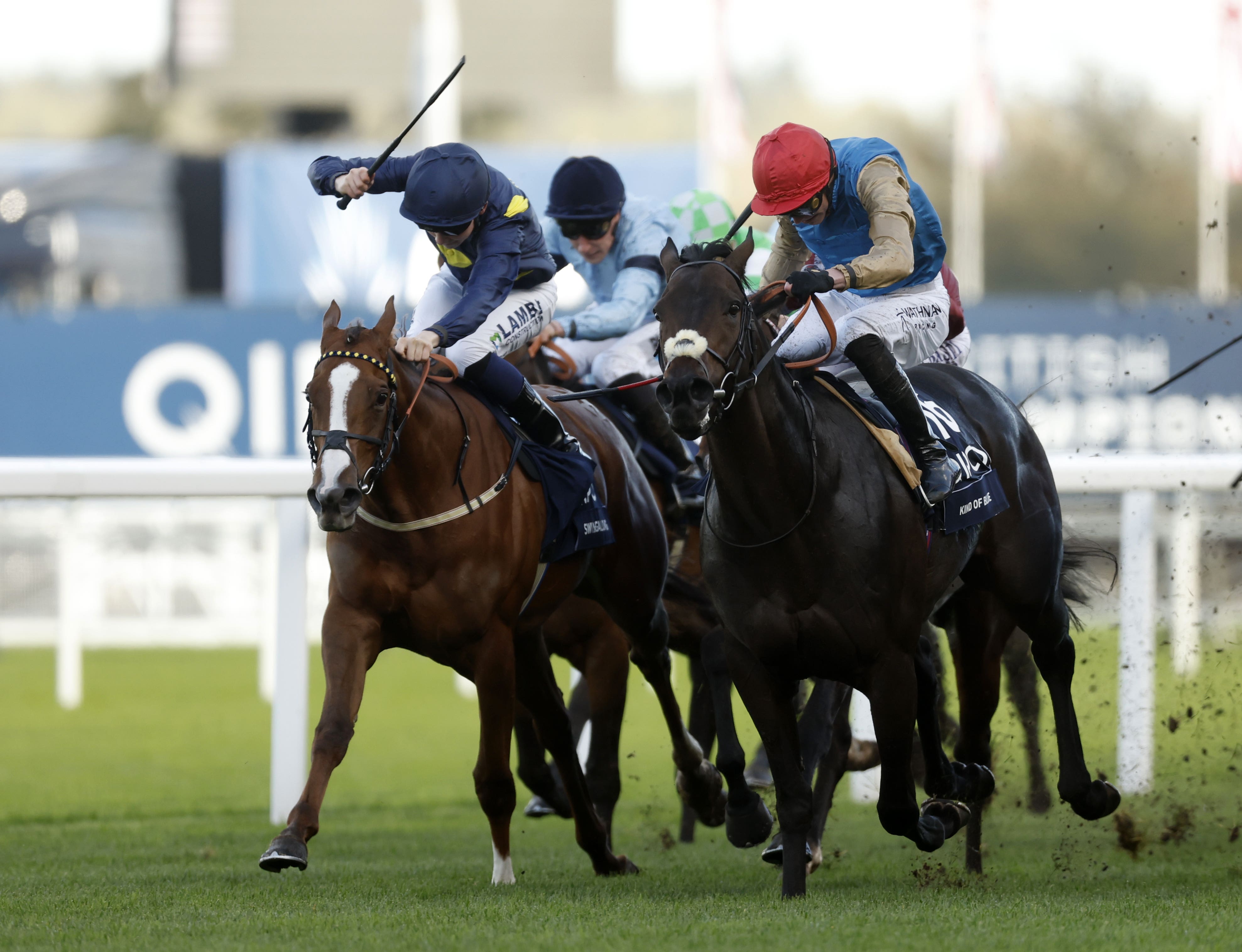 Kind Of Blue (red hat) won at Ascot on Champions Day